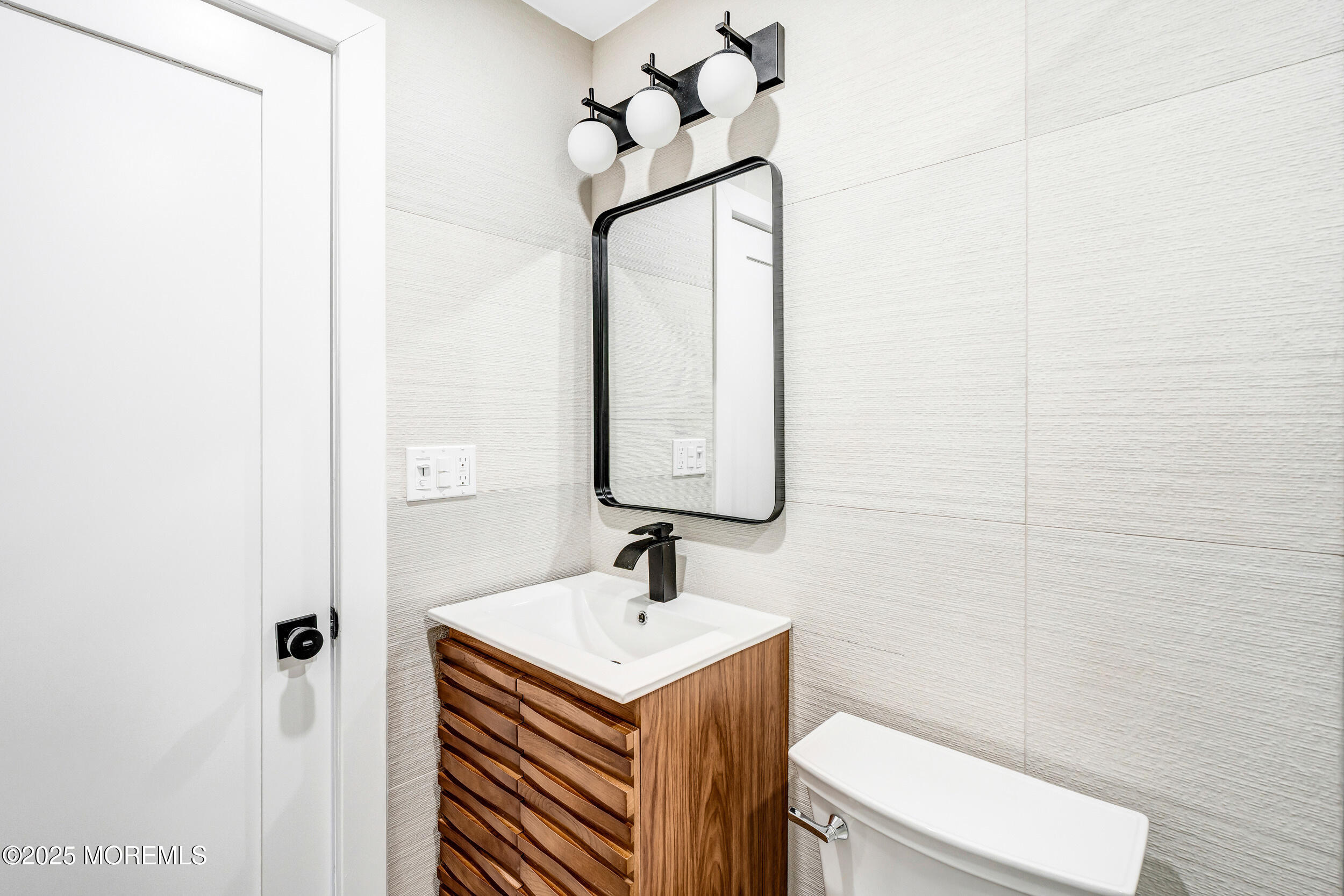 448 Monmouth Road West Long Branch, NJ 07764 - Photo 38 of 51 a bathroom with a sink a toilet and mirror