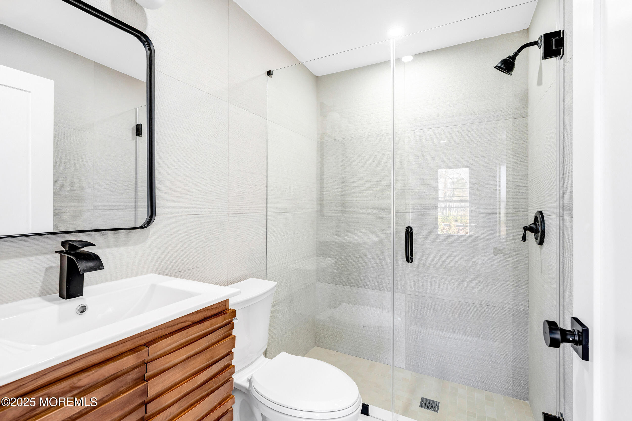 448 Monmouth Road West Long Branch, NJ 07764 - Photo 41 of 51 a bathroom with a sink a toilet a mirror and shower