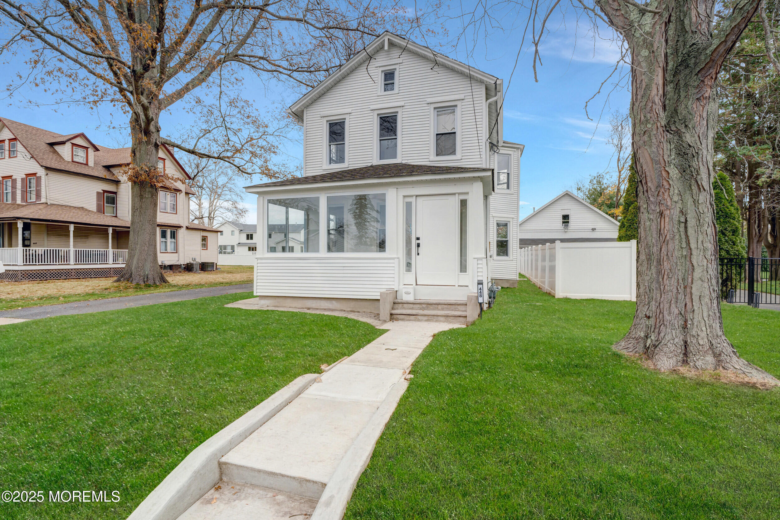 448 Monmouth Road West Long Branch, NJ 07764 - Photo 5 of 35 a view of a white house next to a yard with big trees