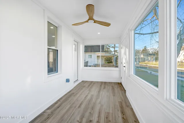 a kitchen with granite countertop white cabinets and stainless steel appliances
