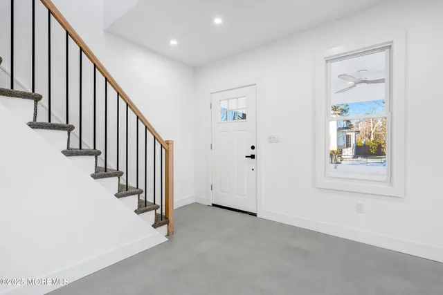 a kitchen with white cabinets and refrigerator