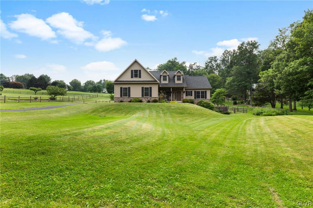 a view of a house with a big yard and palm trees