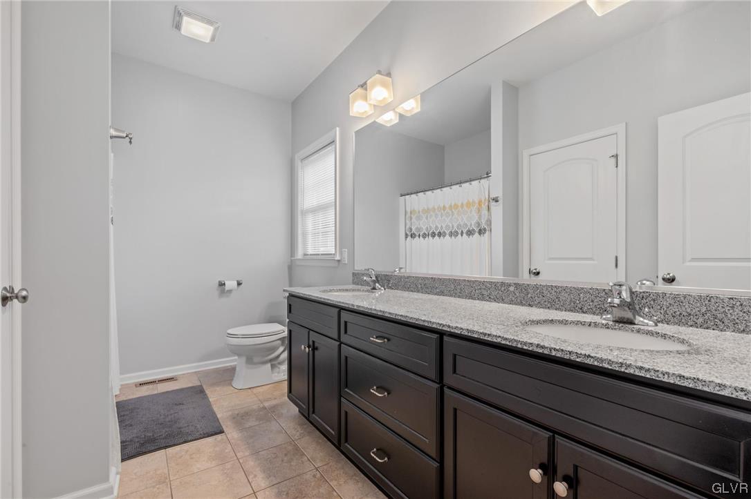 315 Bougher Hill Road Easton, PA 18042 - Photo 9 of 20 a bathroom with a granite countertop sink a toilet and a mirror