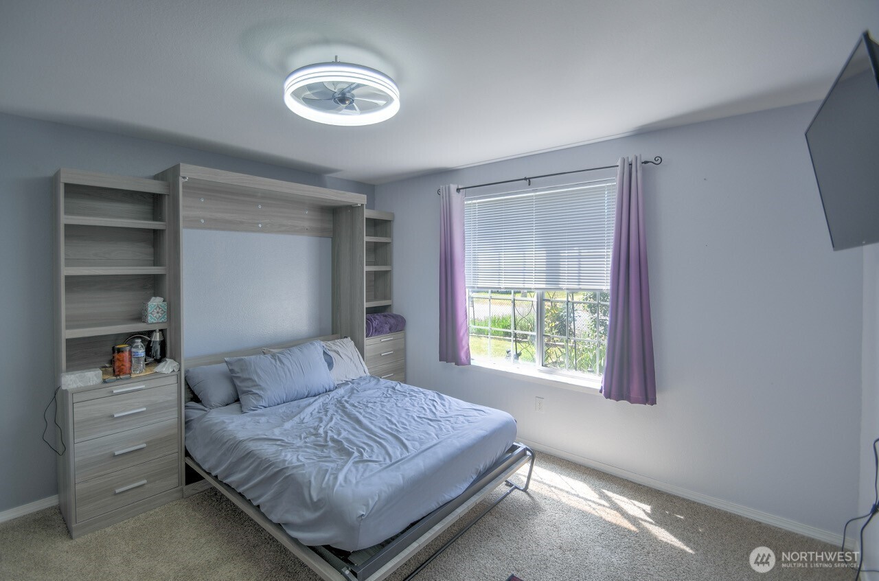 5922 184th Lane Southwest Rochester, WA 98579 - Photo 13 of 34 a bedroom with a bed and a window