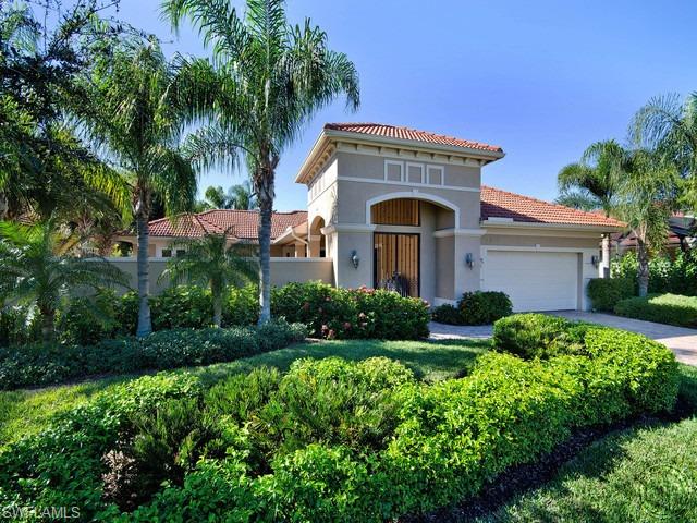 5066 Rustic Oaks Circle Naples, FL 34105 - Photo 1 of 12 a front view of house with yard and green space