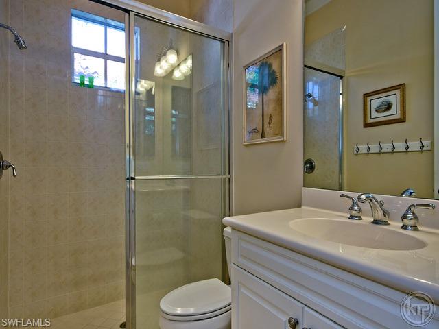 5066 Rustic Oaks Circle Naples, FL 34105 - Photo 11 of 12 a bathroom with a sink a toilet and shower