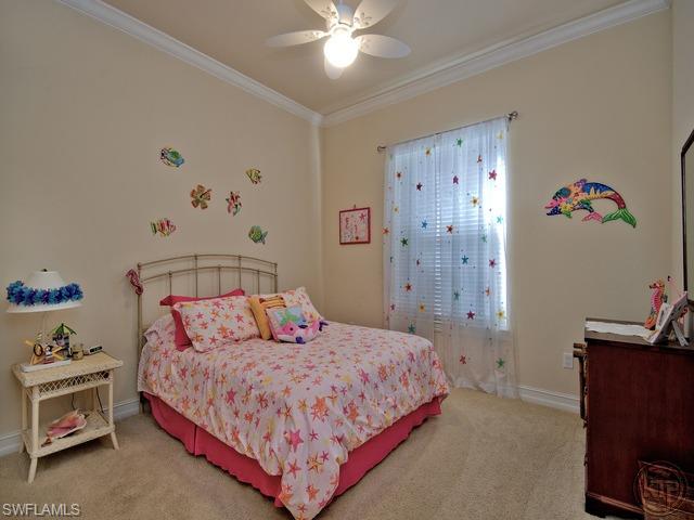 5066 Rustic Oaks Circle Naples, FL 34105 - Photo 12 of 12 a bedroom with a bed and a chandelier