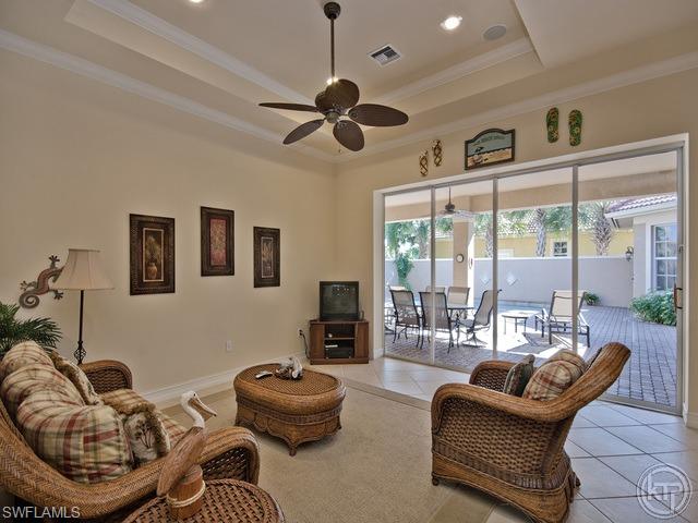 5066 Rustic Oaks Circle Naples, FL 34105 - Photo 4 of 12 a living room with furniture and a large window