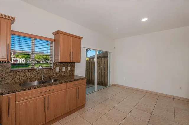 a kitchen with stainless steel appliances a stove a sink and a microwave