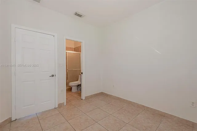 a bathroom with a toilet sink vanity and mirror