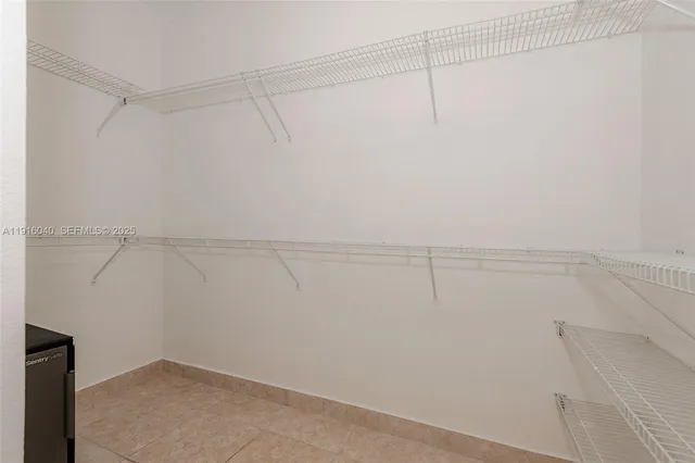 a bathroom with a sink a toilet a mirror and shower