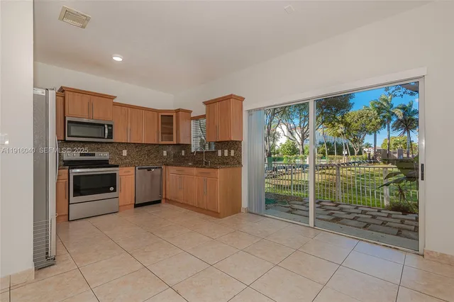 a view of a kitchen with a sink and a stove top oven