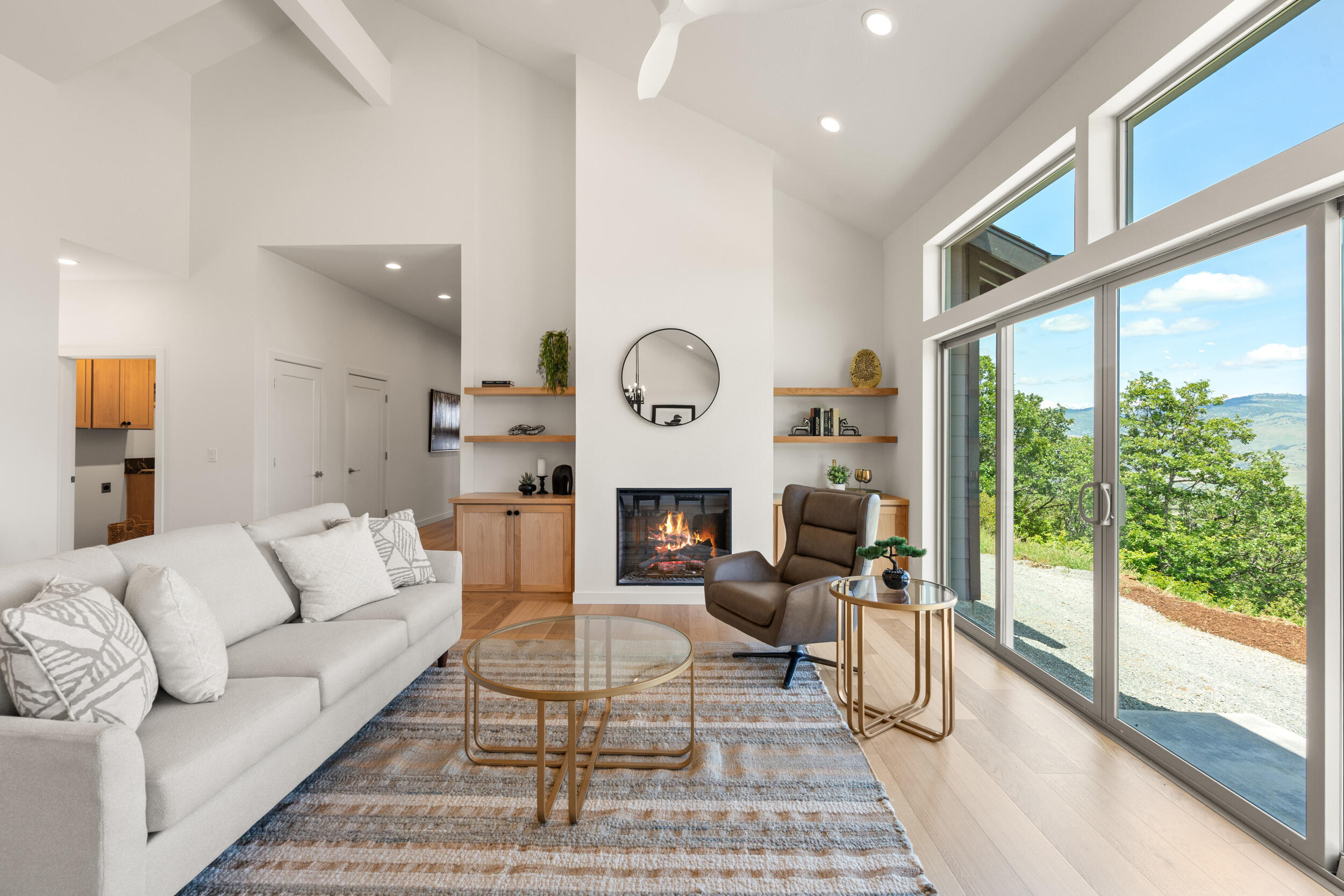 3060 Ashland Mine Road Talent, OR 97540 - Photo 6 of 43 a living room with furniture a fireplace and a floor to ceiling window