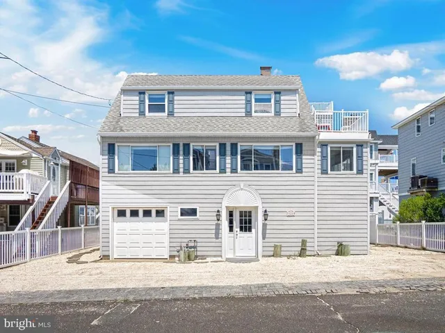 a front view of a house with a street