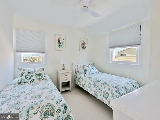 a living room with furniture a flat screen tv and a large window
