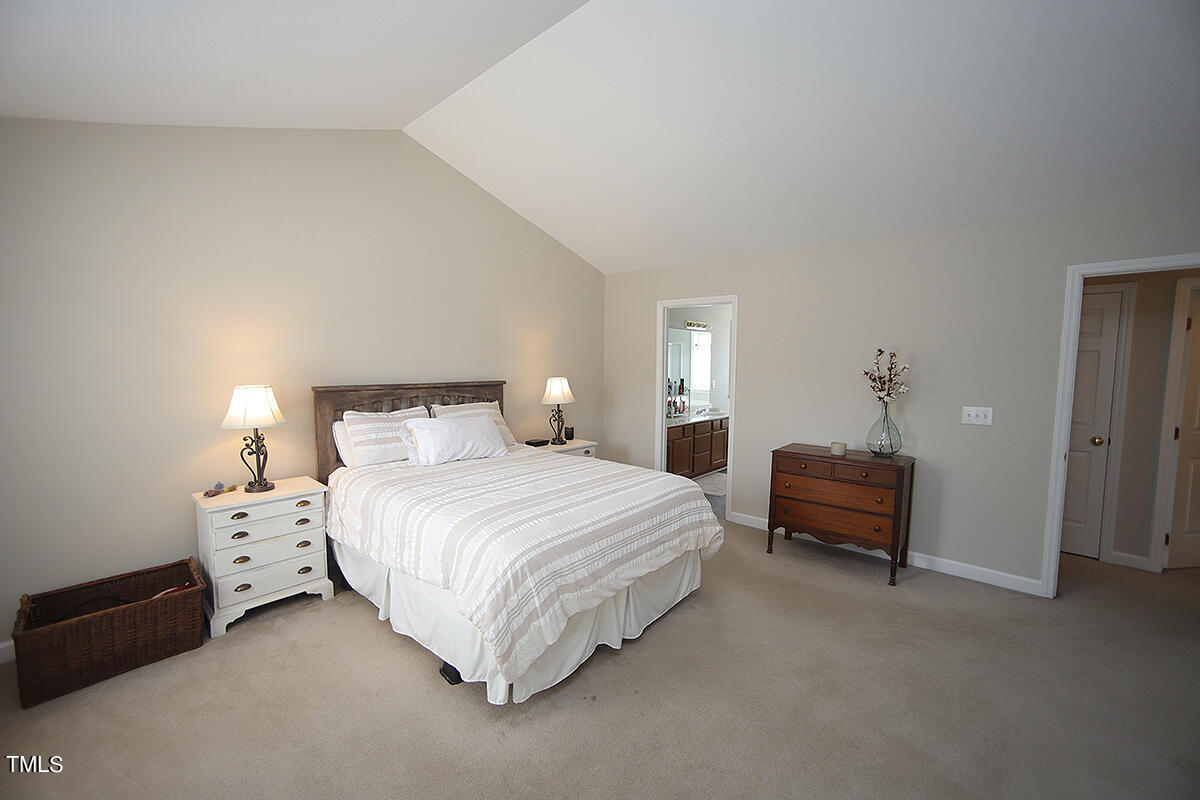 3557 Dewing Drive Raleigh, NC 27616 - Photo 19 of 32 a bedroom with bed and a chandelier