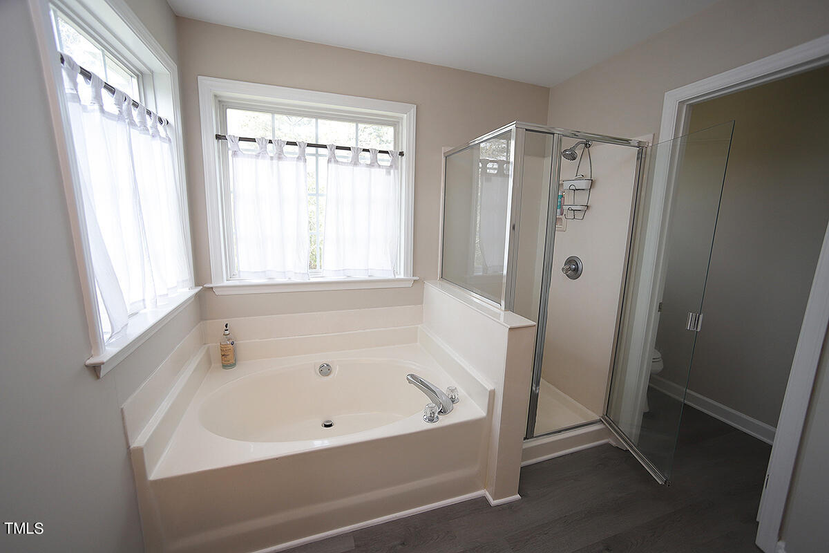 3557 Dewing Drive Raleigh, NC 27616 - Photo 21 of 32 a white bath tub sitting next to a window