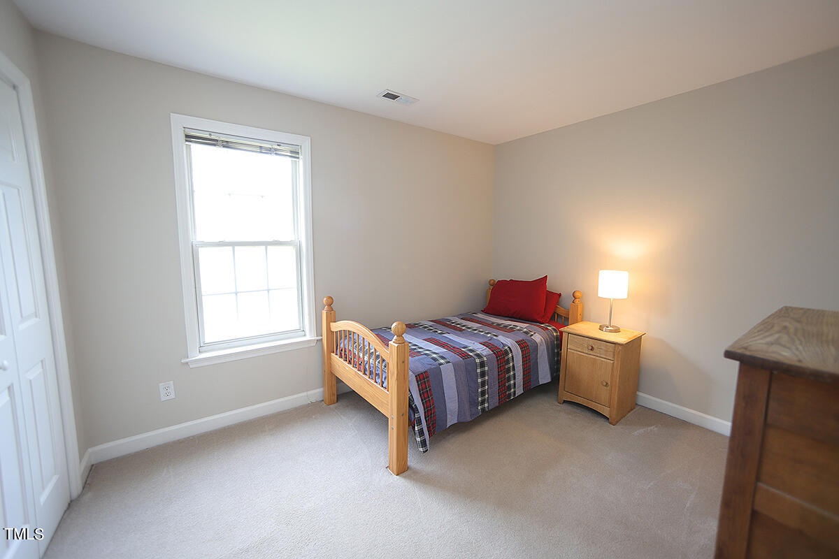 3557 Dewing Drive Raleigh, NC 27616 - Photo 23 of 32 a room with a bed and a window