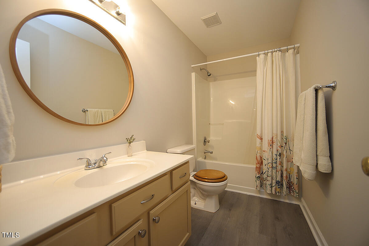 3557 Dewing Drive Raleigh, NC 27616 - Photo 25 of 32 a bathroom with a sink and a mirror