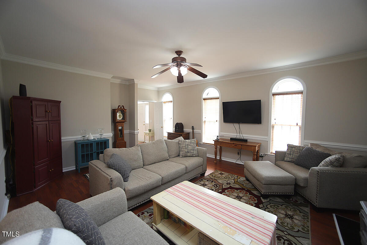 3557 Dewing Drive Raleigh, NC 27616 - Photo 9 of 32 a living room with furniture a ceiling fan and a window