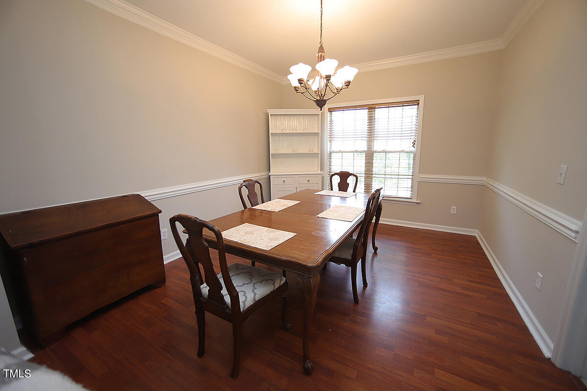 3557 Dewing Drive Raleigh, NC 27616 - Photo 10 of 32 a view of a dining room with furniture wooden floor and chandelier