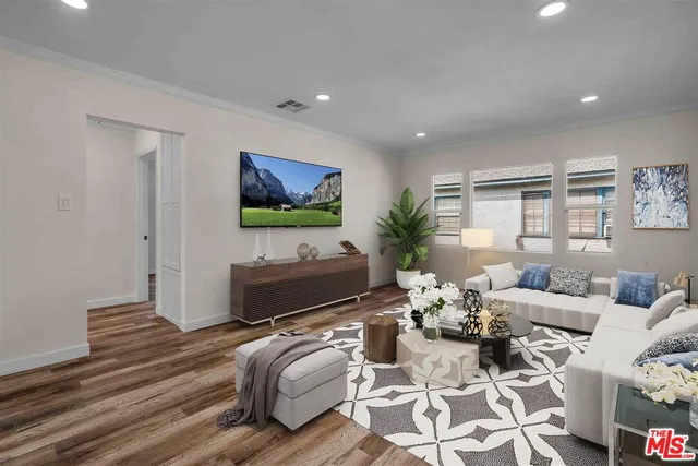 a living room with furniture a flat screen tv and a dining table