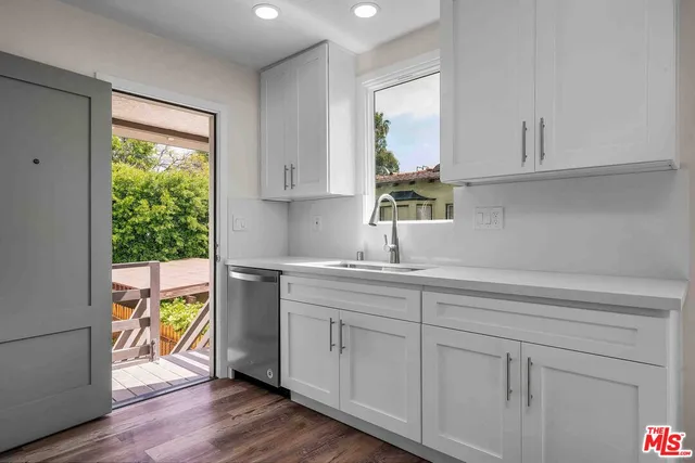 a kitchen with stainless steel appliances granite countertop a stove and a wooden cabinets