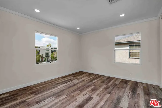 a room with a wooden floor and a window