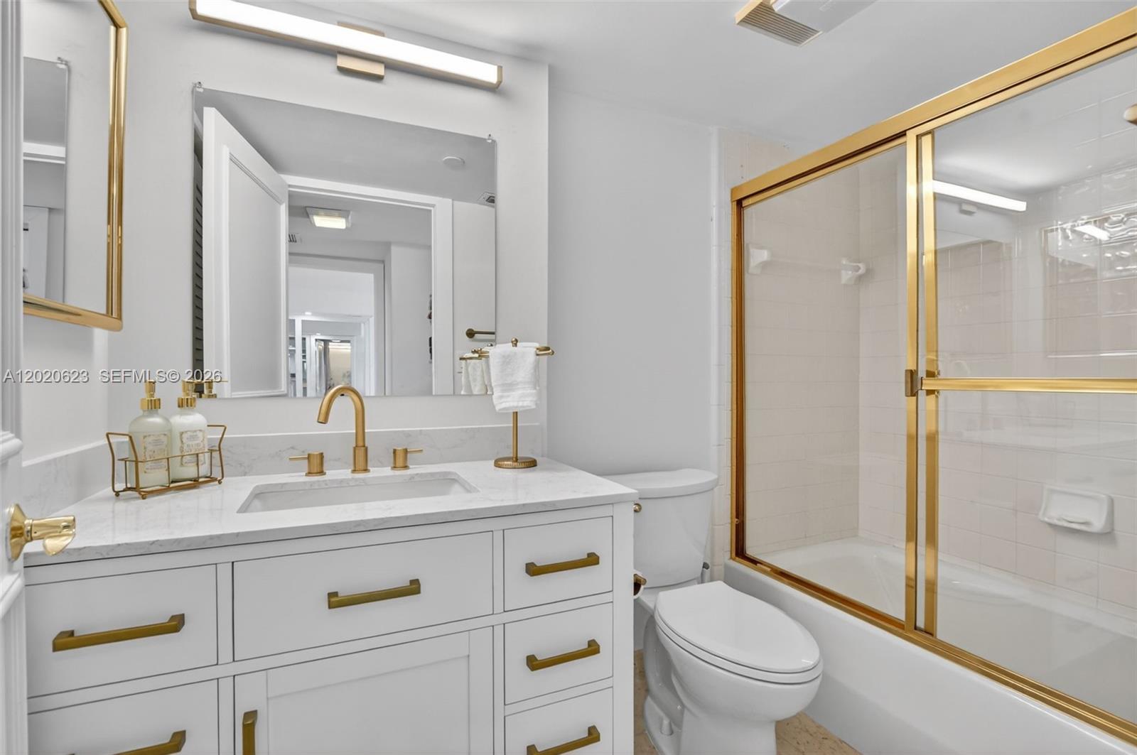 4101 North Ocean Boulevard, Unit 1605 Boca Raton, FL 33431 - Photo 19 of 35 a spacious bathroom with a granite countertop sink toilet mirror and a shower