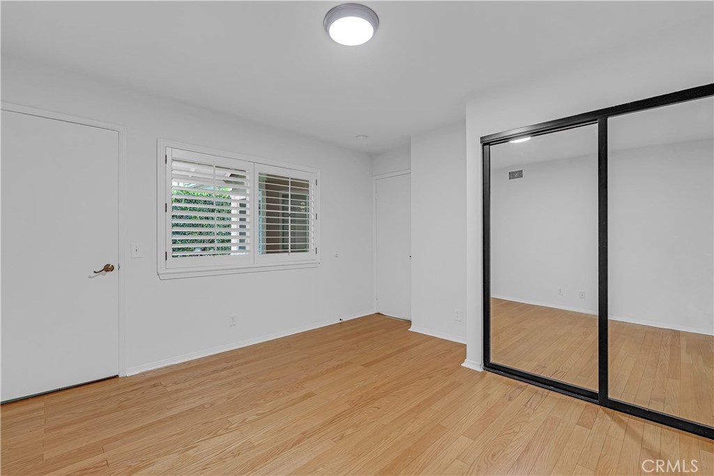 19451 Eagle Ridge Lane Porter Ranch, CA 91326 - Photo 27 of 59 an empty room with wooden floor and windows