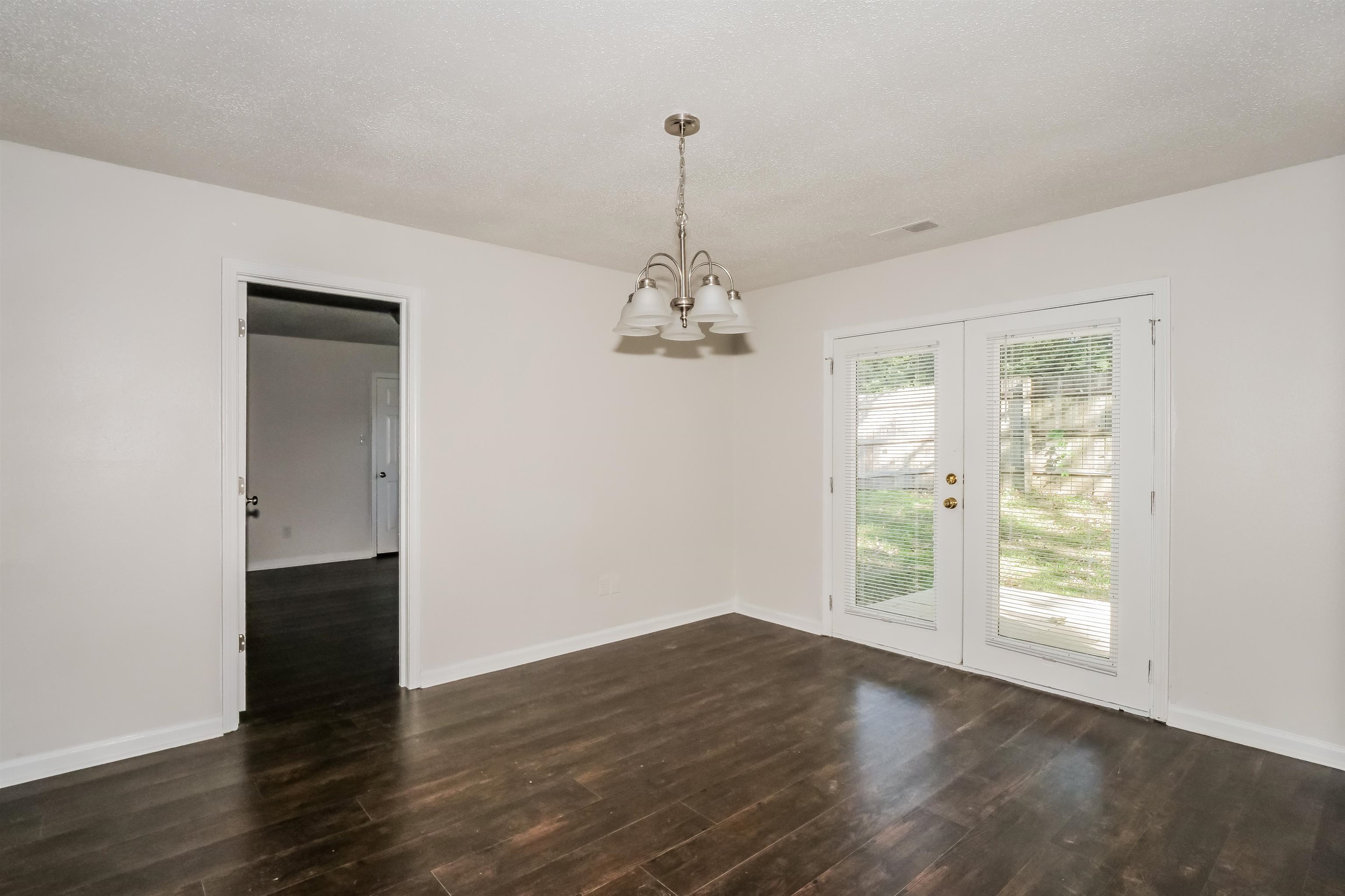 3824 Windermere Road Memphis, TN 38128 - Photo 5 of 16 wooden floor in an empty room with a window