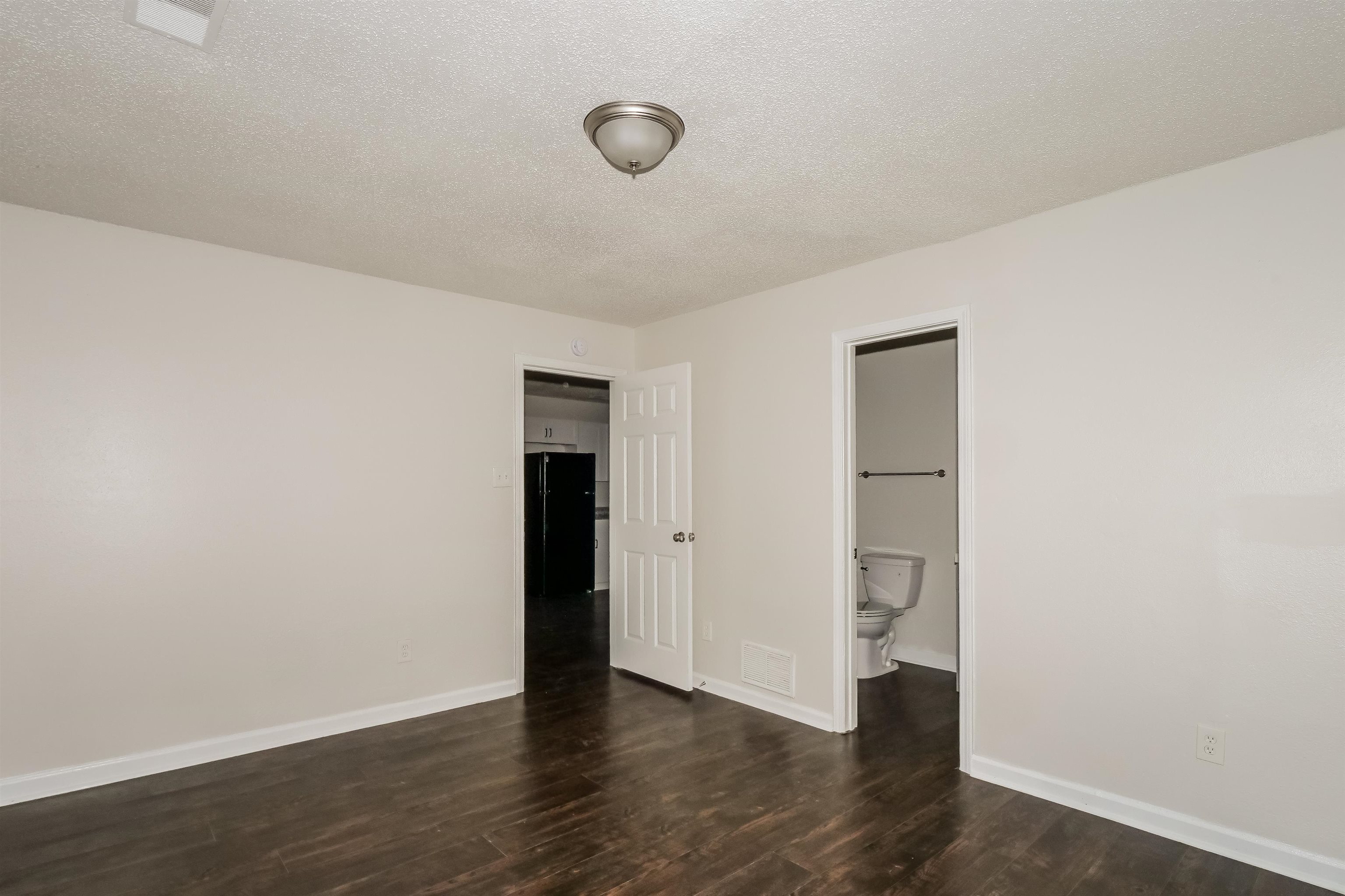 3824 Windermere Road Memphis, TN 38128 - Photo 8 of 16 a view of an empty room with wooden floor and closet