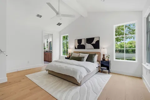 a bedroom with a large bed and a large window