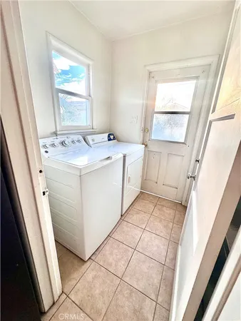 a room with washing machine and window