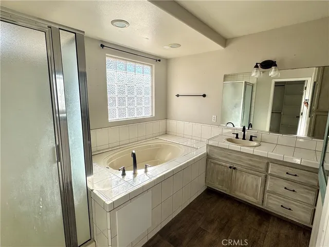a bathroom with a tub sink and mirror