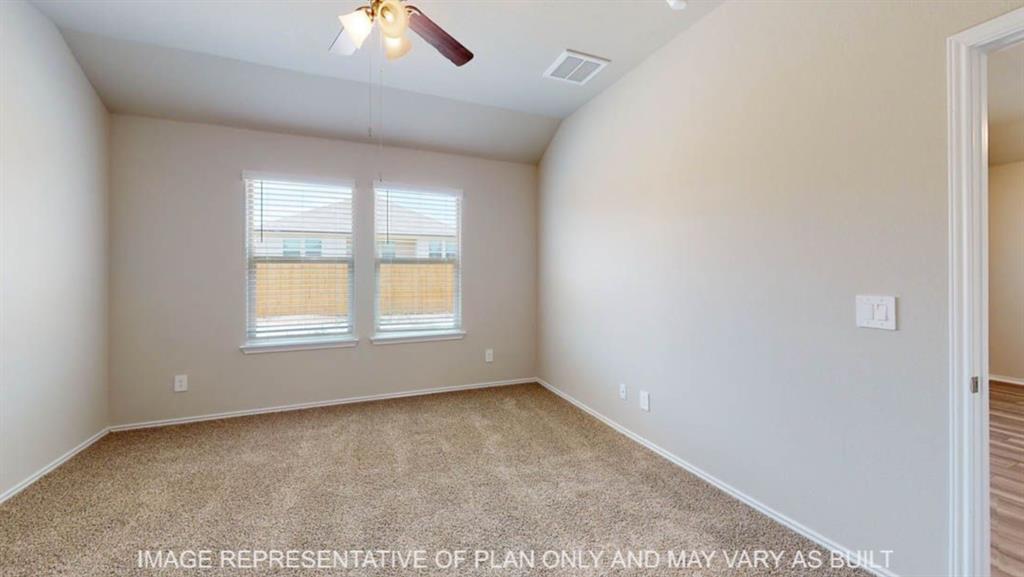 10409 Altair Drive Waco, TX 76708 - Photo 7 of 11 Carpeted flooring, vaulted ceiling, dual windows with blinds, and ceiling fan with integrated lighting