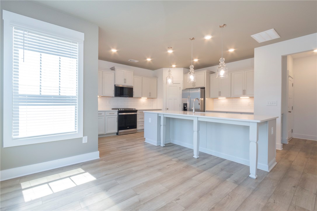 607 WH Kay Lane Anderson, SC 29621 - Photo 12 of 48 Culinary dreams come alive in this well-lit kitchen with a spacious island and gleaming stainless steel appliances.
