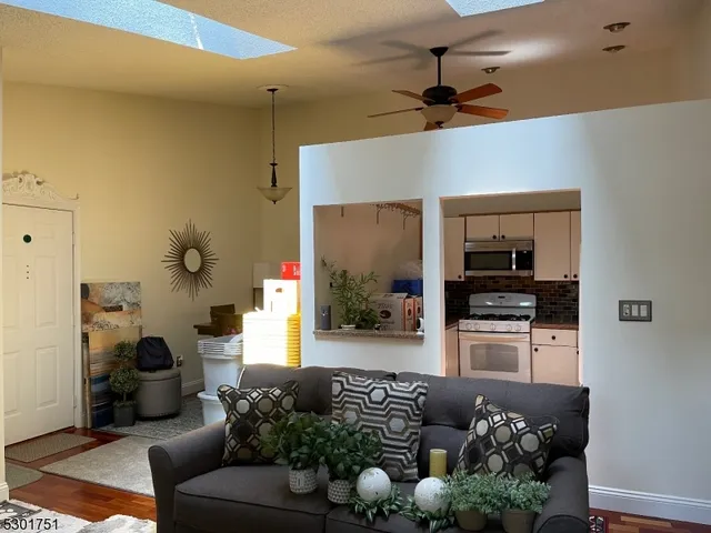 a living room with furniture and flowers