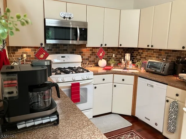 a kitchen with stainless steel appliances a stove a sink and a microwave