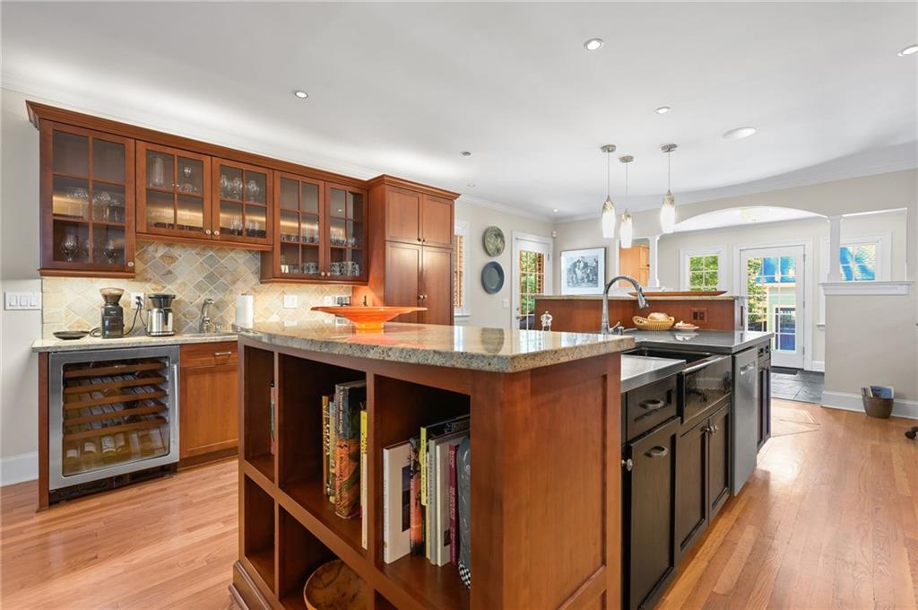 1735 Johnson Road Northeast Atlanta, GA 30306 - Photo 15 of 54 a kitchen with stainless steel appliances granite countertop a stove top oven a sink dishwasher and a refrigerator with wooden floor
