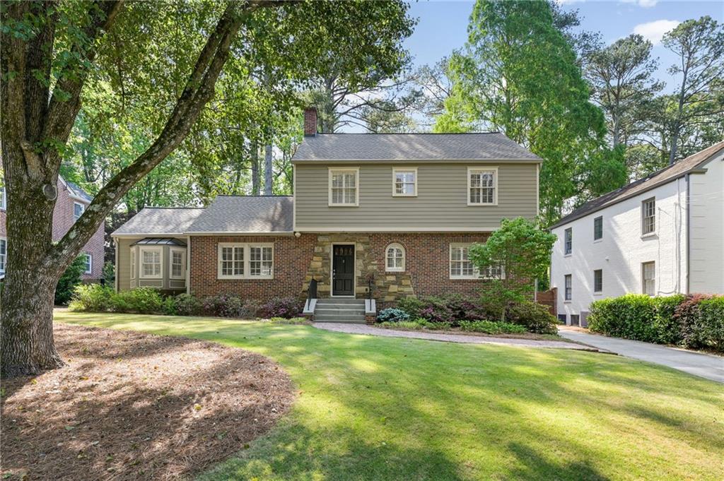 1735 Johnson Road Northeast Atlanta, GA 30306 - Photo 2 of 54 a front view of a house with a yard and trees