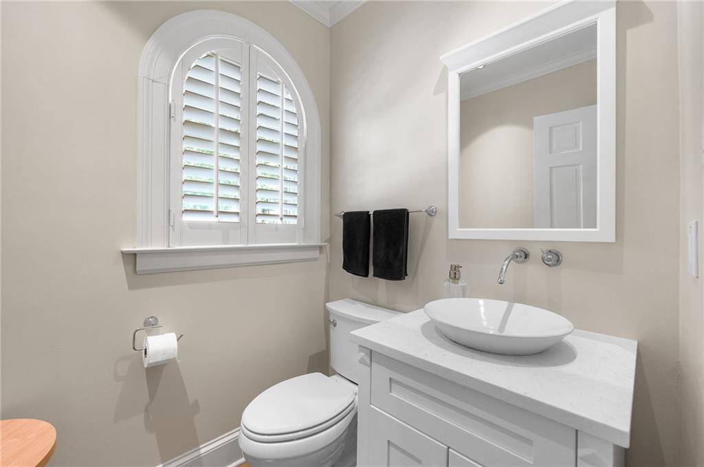 1735 Johnson Road Northeast Atlanta, GA 30306 - Photo 24 of 54 a bathroom with a toilet a sink and a mirror