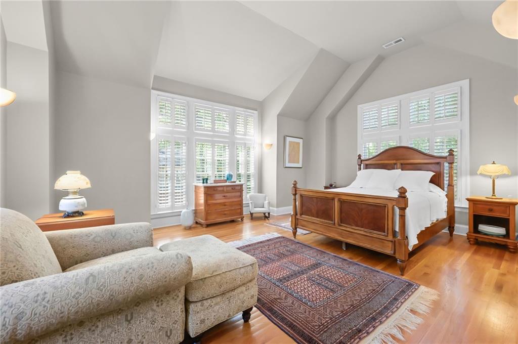 1735 Johnson Road Northeast Atlanta, GA 30306 - Photo 25 of 54 a bedroom with a bed and wooden floor