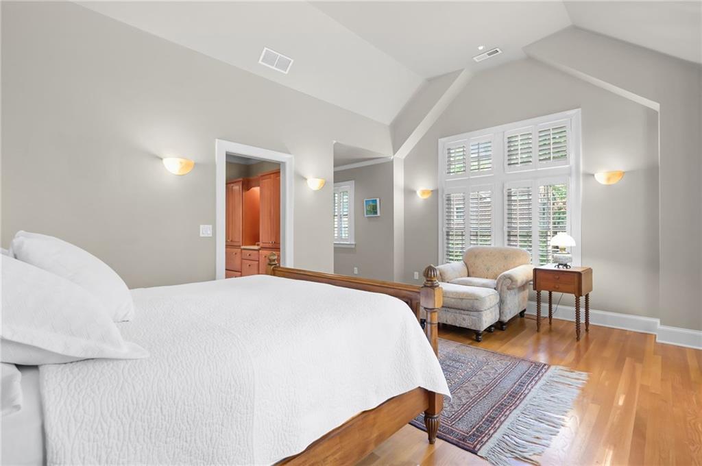 1735 Johnson Road Northeast Atlanta, GA 30306 - Photo 27 of 54 a spacious bedroom with a bed and wooden floor