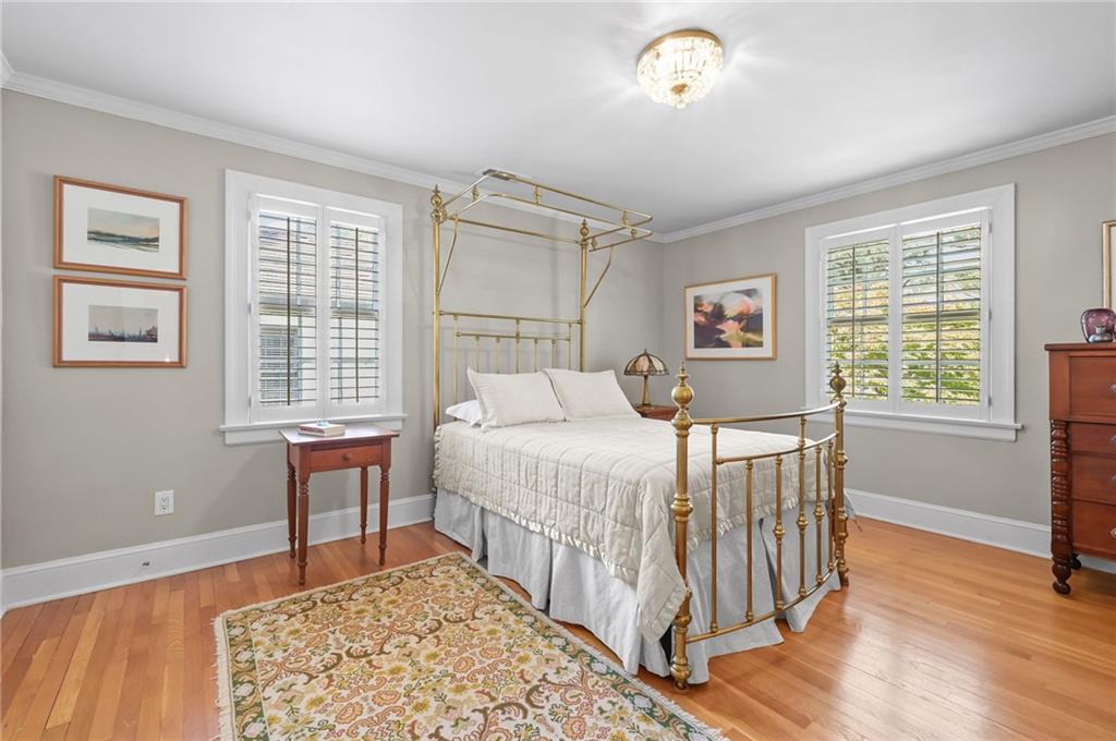 1735 Johnson Road Northeast Atlanta, GA 30306 - Photo 32 of 54 a bedroom with a bed and a table in it with window