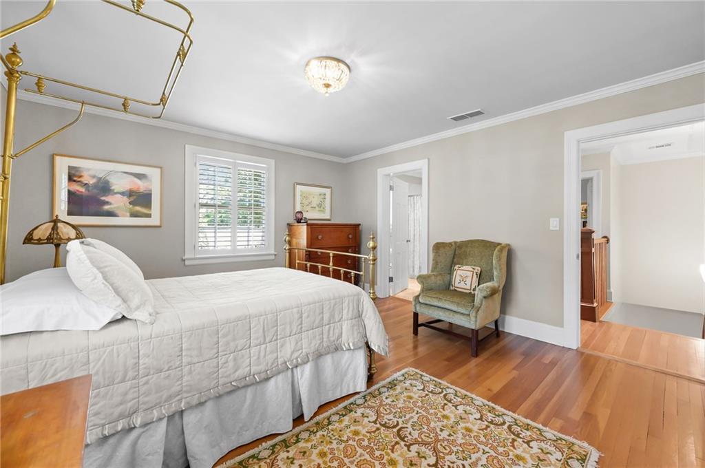 1735 Johnson Road Northeast Atlanta, GA 30306 - Photo 33 of 54 a bedroom with a bed and wooden floor