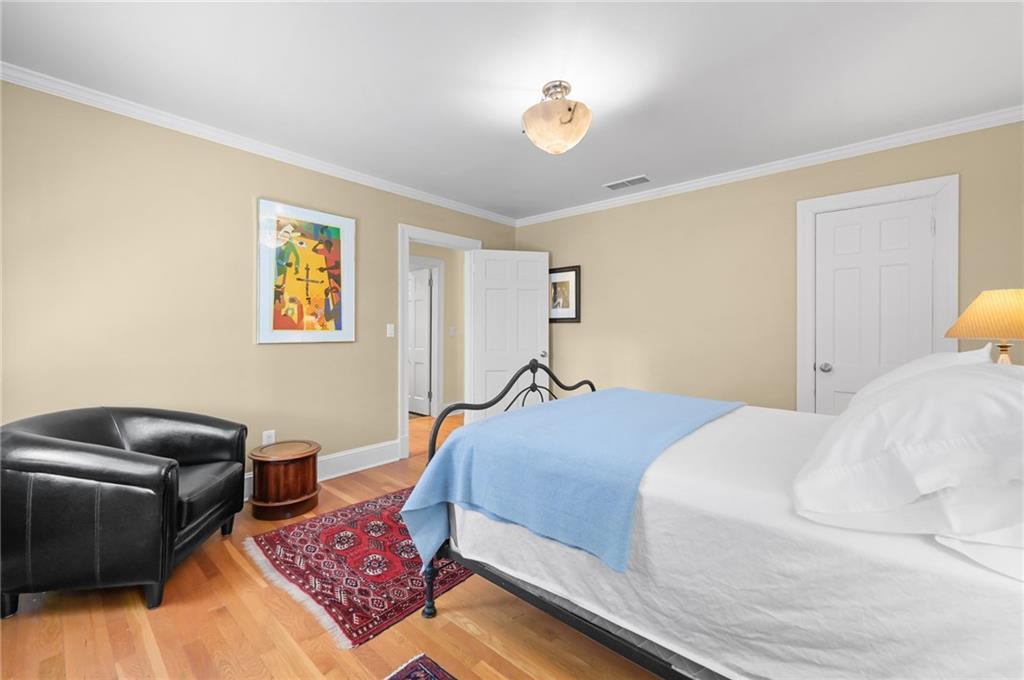 1735 Johnson Road Northeast Atlanta, GA 30306 - Photo 36 of 54 a bedroom with a bed dresser and wooden floor