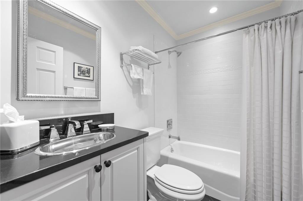 1735 Johnson Road Northeast Atlanta, GA 30306 - Photo 37 of 54 a bathroom with a granite countertop sink toilet and shower