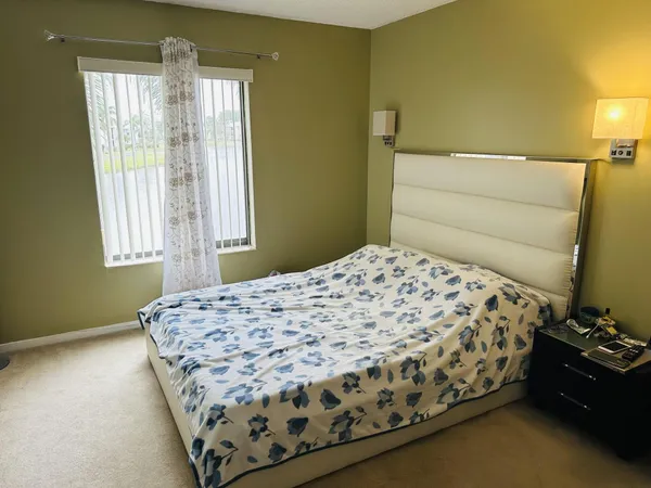 a bedroom with a bed and window