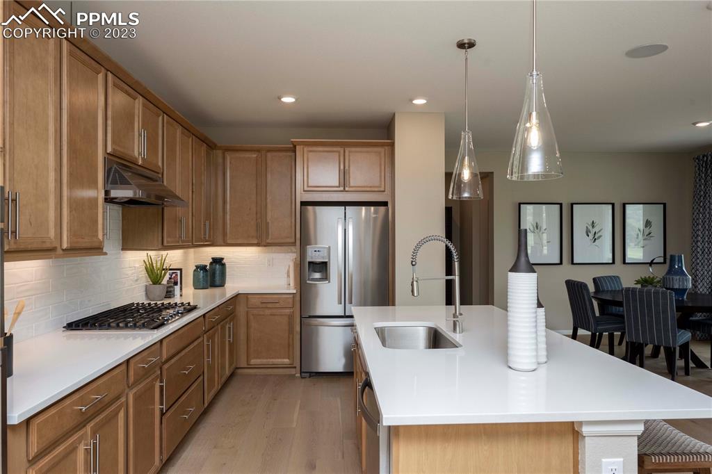 631 Felicity Loop Castle Rock, CO 80109 - Photo 12 of 33 a kitchen with kitchen island granite countertop a sink a counter top space stainless steel appliances and cabinets